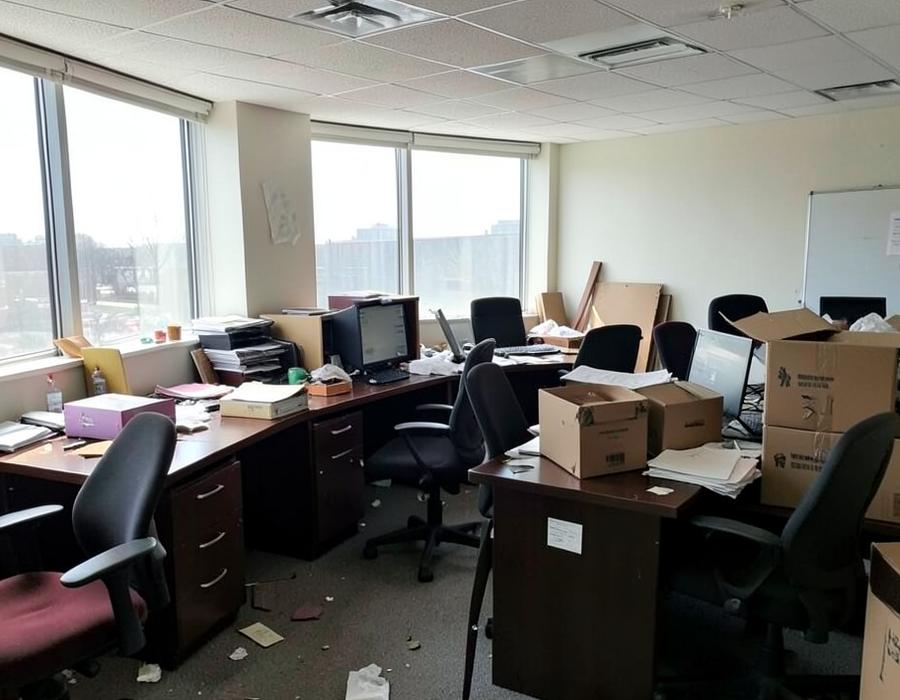 Office space being cleared of old desks, chairs and boxes