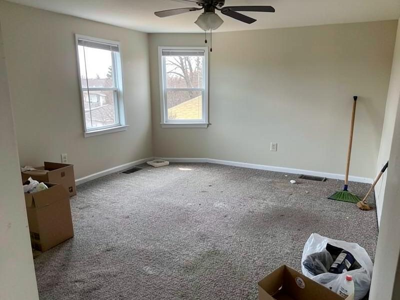 Empty living room with bare floors after a full house cleanout